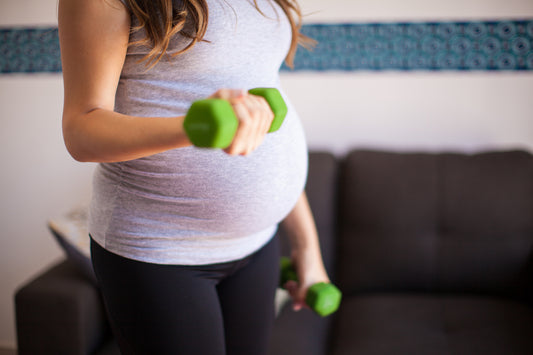 pregnant woman performing a dumbbell curle